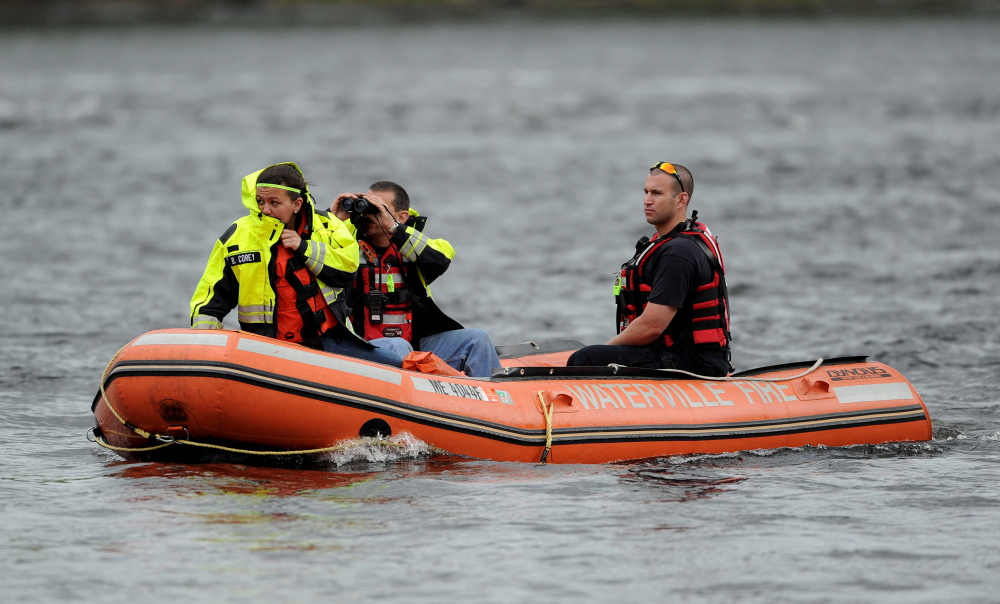 Eyes on the water: A Waterville fire department crew searches the Kennebec River on Saturday near the Hathaway Creative Center for a person reported likely to be in the water.