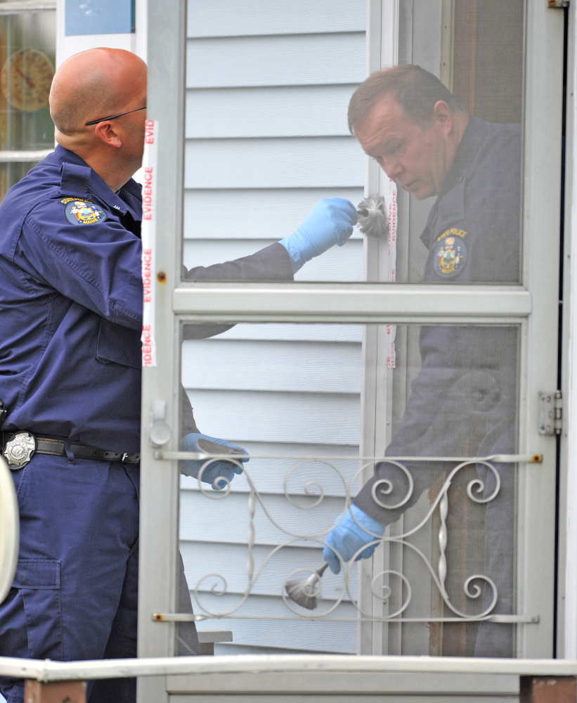 ON SCENE: Investigators with the Maine State Police Major Crimes Unit dusts for fingerprints at the residence of Aurele Fecteau, 92, who was found dead in his home on Brooklyn Street in Waterville on Friday.