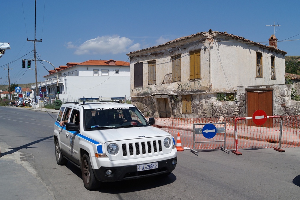Police patrol an old building that was damaged after a magnitude 6.3 earthquake on the northeastern Aegean Sea island of Lemnos, Greece, on Saturday.