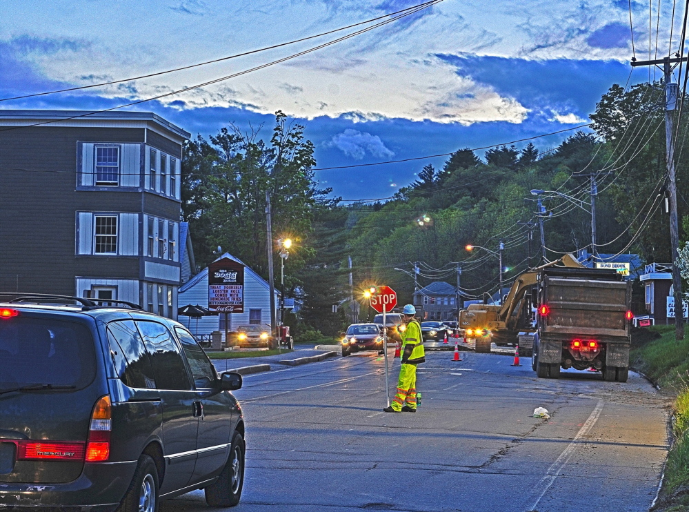 Flagged down: Flaggers alternate the direction of traffic flow in one lane through an overnight construction zone Wednesday on Mount Vernon Avenue in Augusta.