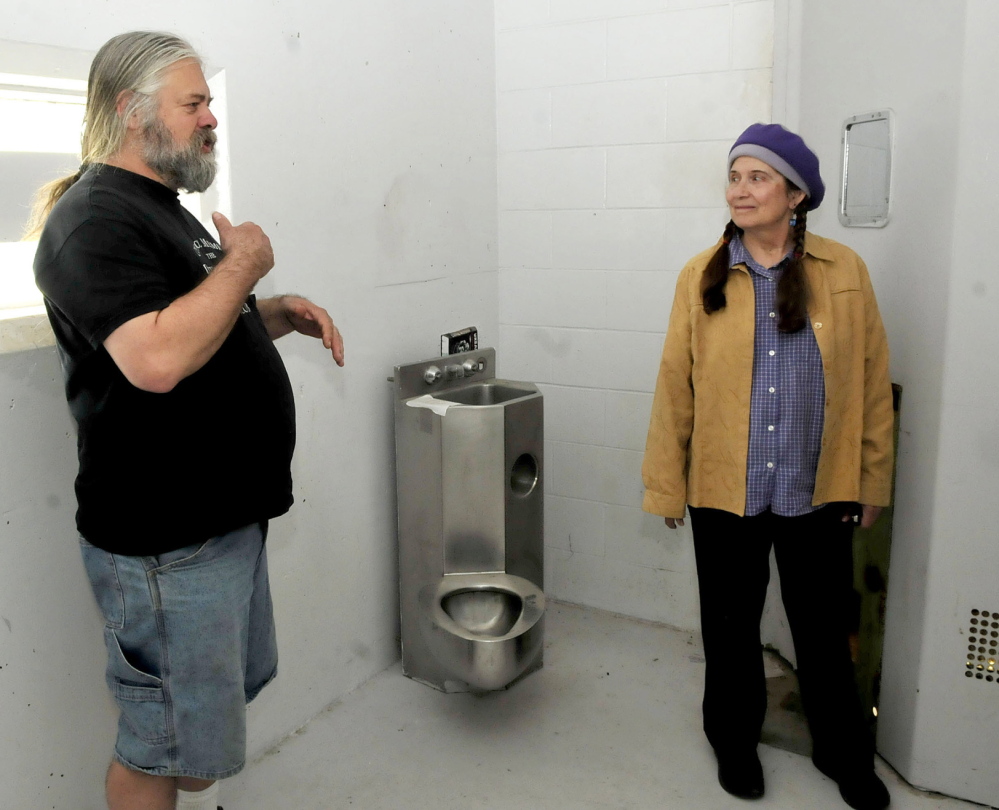 JAIL HOUSE ROCK: Timothy Smith and Annie Stillwater Gray speak on Thursday about plans to transform cellblock E13 into a noncommercial and community based radio station at the former Somerset County Jail in Skowhegan. The object in background is a combination toilet and sink used by inmates.