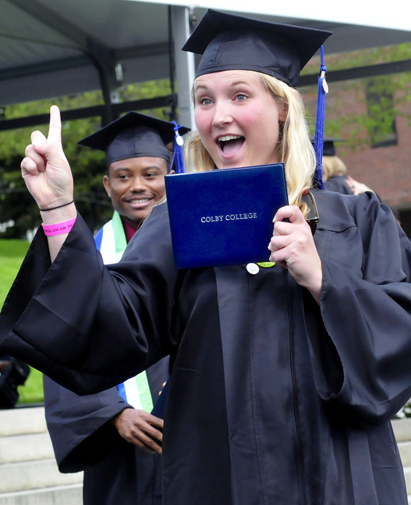 NUMBER ONE: Colby College graduate Jenna Mahaffie shows off her diploma she just received during the 193rd commencement at the Waterville college on Sunday.