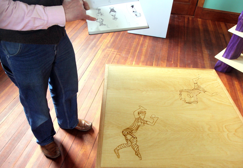 BEFORE AND AFTER: Dutch woodworker Erik Groenhout shows a sketch book he used to create a weave table on display in his gallery at the old Oddfellows Hall in Mt. Vernon on Sunday. Groenhout has slowly been restoring the building since acquiring it in 2011.