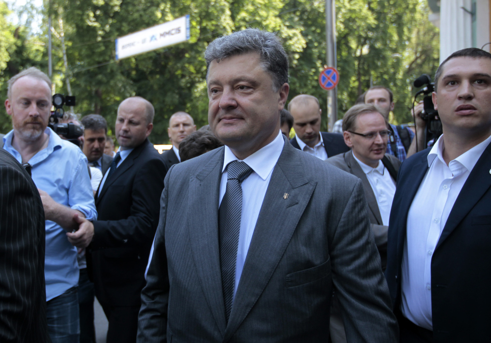 Ukrainian presidential candidate Petro Poroshenko speaks to press at a polling station after his vote during the presidential election in Kiev, Ukraine, on Sunday. An exit poll showed the billionaire candy-maker won Ukraine’s presidential election outright Sunday in the first round – a vote that authorities hoped would unify the fractured nation.