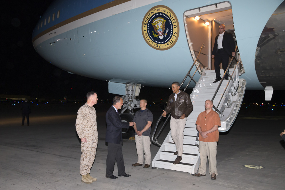 U.S. Ambassador to Afghanistan James Cunningham, second from left, and Marine Gen. Joseph Dunford, commander of the U.S.-led International Security Assistance Force, left, greet President Obama as he steps off Air Force One at Bagram Air Field on Sunday.