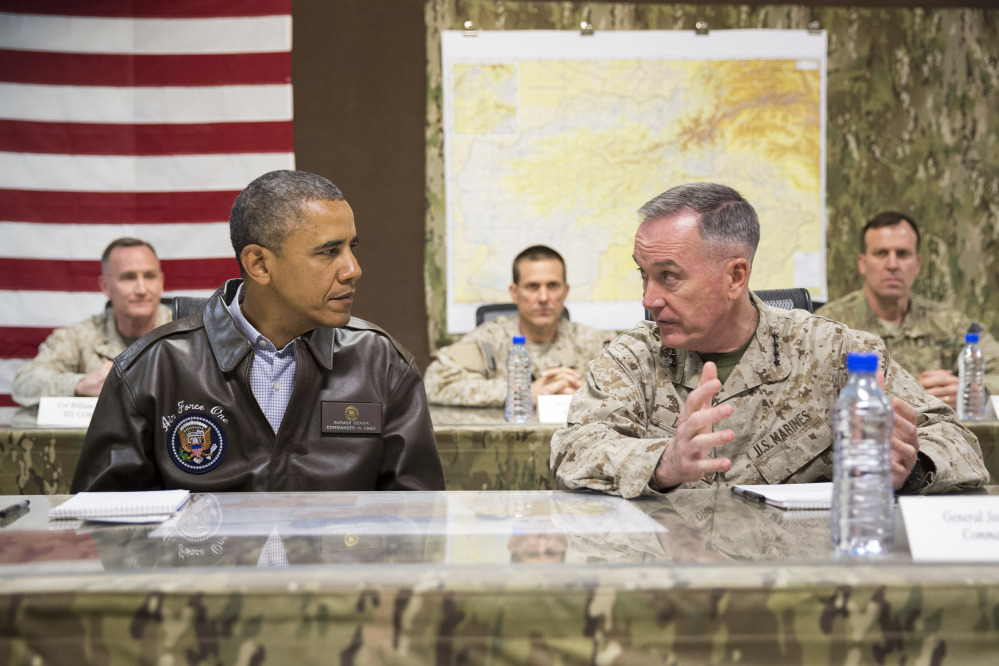 President Barack Obama gets a briefing by Marine Gen. Joseph Dunford, commander of the U.S.-led International Security Assistance Force, right, after arriving at Bagram Air Field for an unannounced visit Sunday.