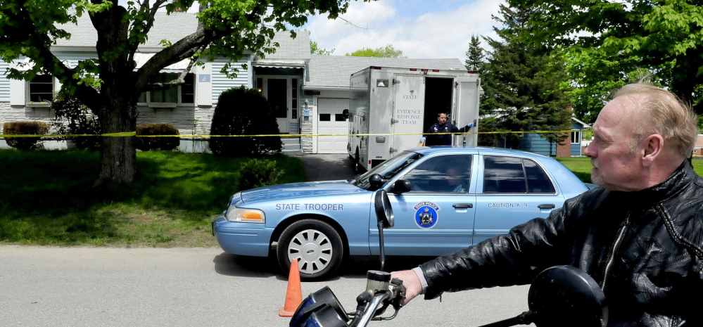 ACTIVE INVESTIGATION: Paul Fecteau watches as a Maine State Police detective exits a Maine State Police Major Crime Unit vehicle outside the cordoned off home of his father Aurele Fecteau’s home in Waterville on Sunday. Aurele Fecteau was found dead by his elder brother Ernest last Friday, according to Paul Fecteau. The death was ruled a homicide on Sunday.