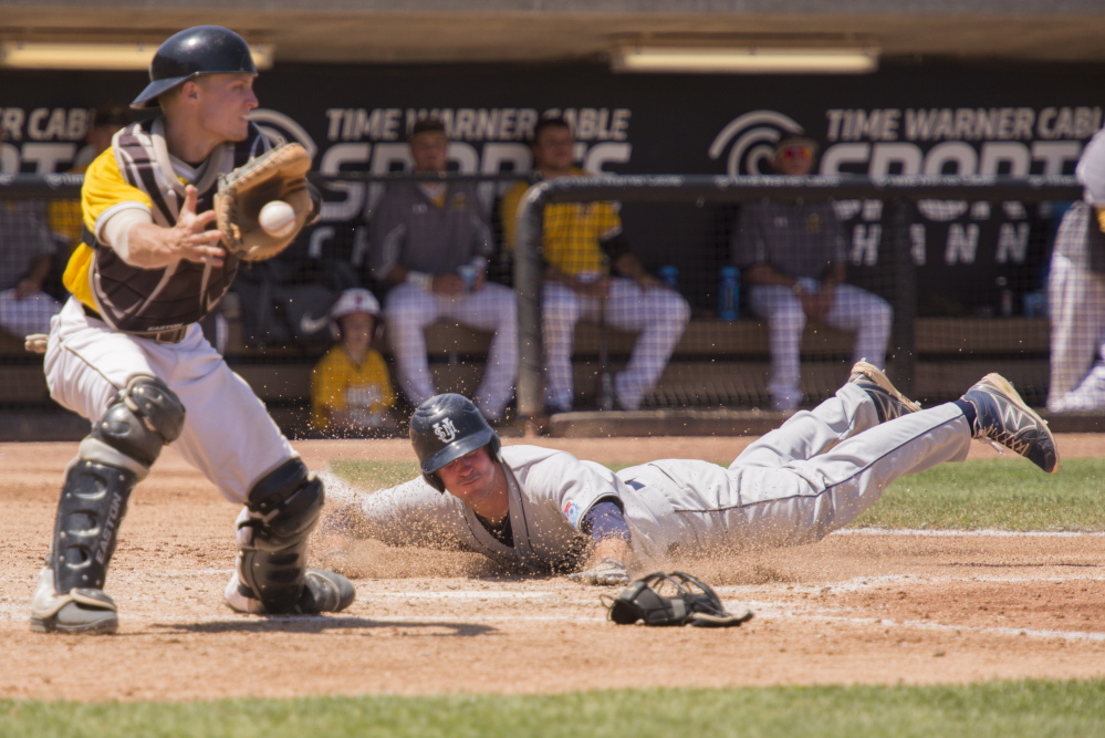 University of Southern Maine’s Jake Glauser slides in safe at home for the Huskies’ first run of the game during the fifth inning Sunday against Baldwin Wallace in the NCAA Division III baseball championships at Appleton, Wis. USM overcame a 3-0 deficit and avoided elimination with an 11-5 victory.