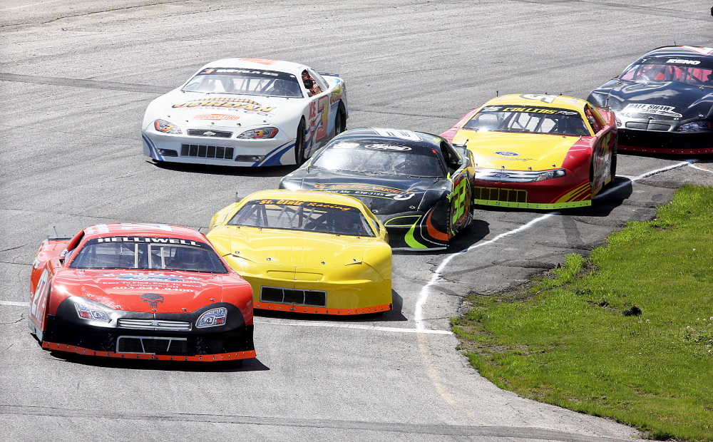 A BATTLE FOR THE LEAD: Dave St. Clair, of Liberty, second from left, battles for the lead with Wayne Helliwell Jr., of Dover, N.H., during a Late Model qualifying heat for the Coastal 200 at Wiscasset Speedway on Sunday.