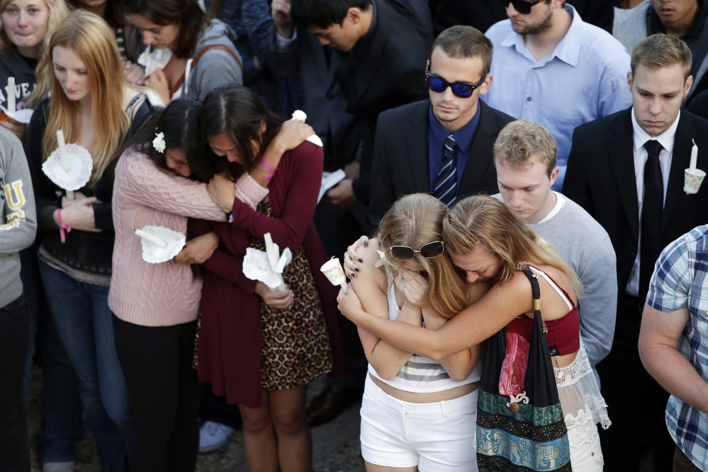 Students comfort each other during a candlelight vigil held to honor the victims of Friday night’s mass shooting on Saturday on the campus of the University of California, Santa Barbara. Sheriff’s officials say Elliot Rodger, 22, went on a rampage near UC Santa Barbara, stabbing three people to death at his apartment before shooting and killing three more in a crime spree through a nearby neighborhood.