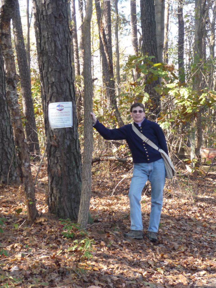 Not Quite a Grave: Tracey McIntire, descendant of Maine Civil War veteran Joseph Herrick, is standing in the Petersburg, N.C. area site of the Battle of Preebles’s Farm, which is where Herrick was captured before being sent to the prison in which he would die.