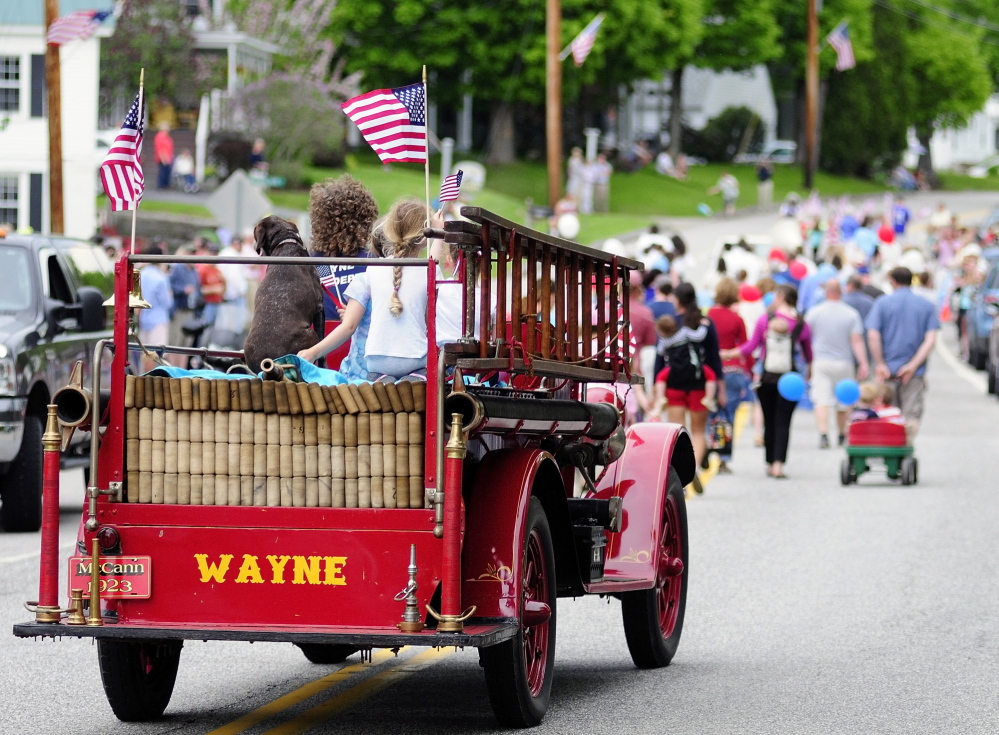 The Wayne Fire Department’s antique 1923 McCann fire truck drives down Main Street during the Memorial Day parade Monday.