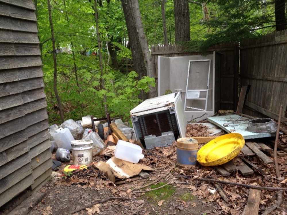 PIles of rubbish: Neighbors have had enough of growing mounds of trash outside buildings taken by the city for non-payment of taxes.