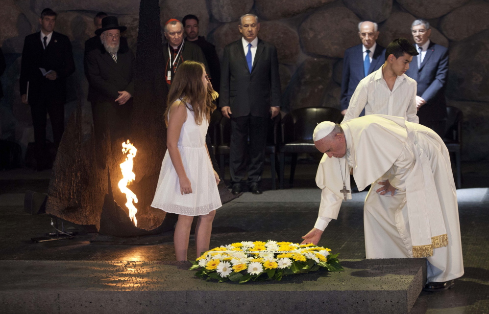 Pope Francis lays a wreath the Hall of Remembrance at the Yad Vashem Holocaust memorial in Jerusalem on Monday, as he concluded his three-day Mideast trip.