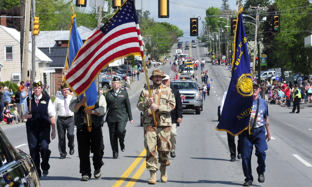 Staff photo by David Leaming ONWARD: The color guard leads the Memorial Day parade in Skowhegan on Monday, May 26, 2014.
