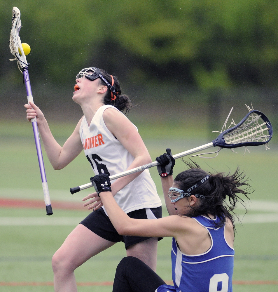 WATERVILLE, ME - MAY 27: Gardiner Area High School's Bryce Smith, left, collides with Morse High School's Maddy Olsen Tuesday May 27, 2014 during a lacrosse match up in Waterville. (Photo by Andy Molloy/Staff Photographer)