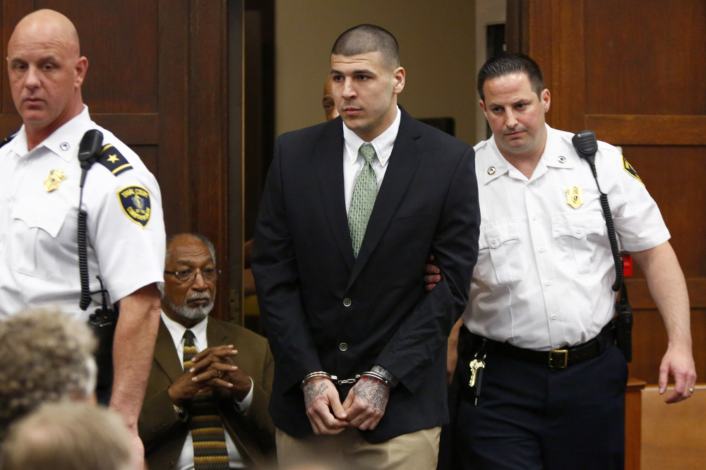 Former New England Patriots tight end Aaron Hernandez is led into the courtroom to be arraigned on homicide charges at Suffolk Superior Court in Boston on Wednesday. Hernandez pleaded not guilty in the shooting deaths of Daniel de Abreu and Safiro Furtado.