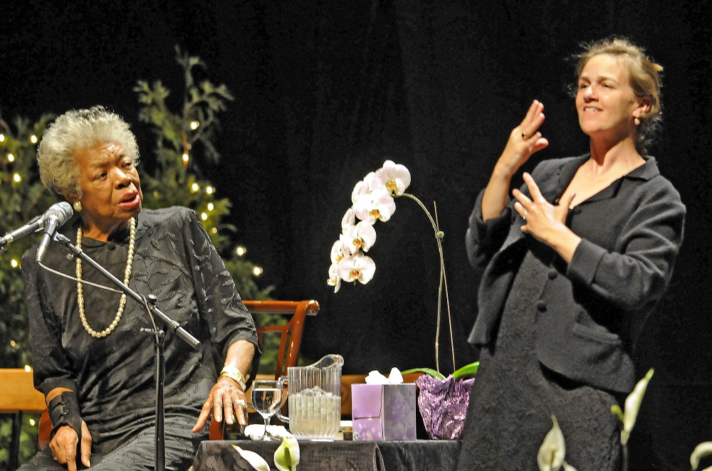 ANGELOU VISIT: Maya Angelou, left, greets greets the crowd at the Augusta Civic Center with a song April 26, 2010. At right is sign language interpreter Margaret Haberman.