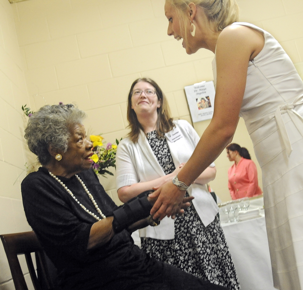 ANGELOY VISIT: Maya Angelou, left, greets University of Maine at Augusta students Jennifer Laney, right, Alice Ireland, and Natasha April 26, 2010 in Augusta.