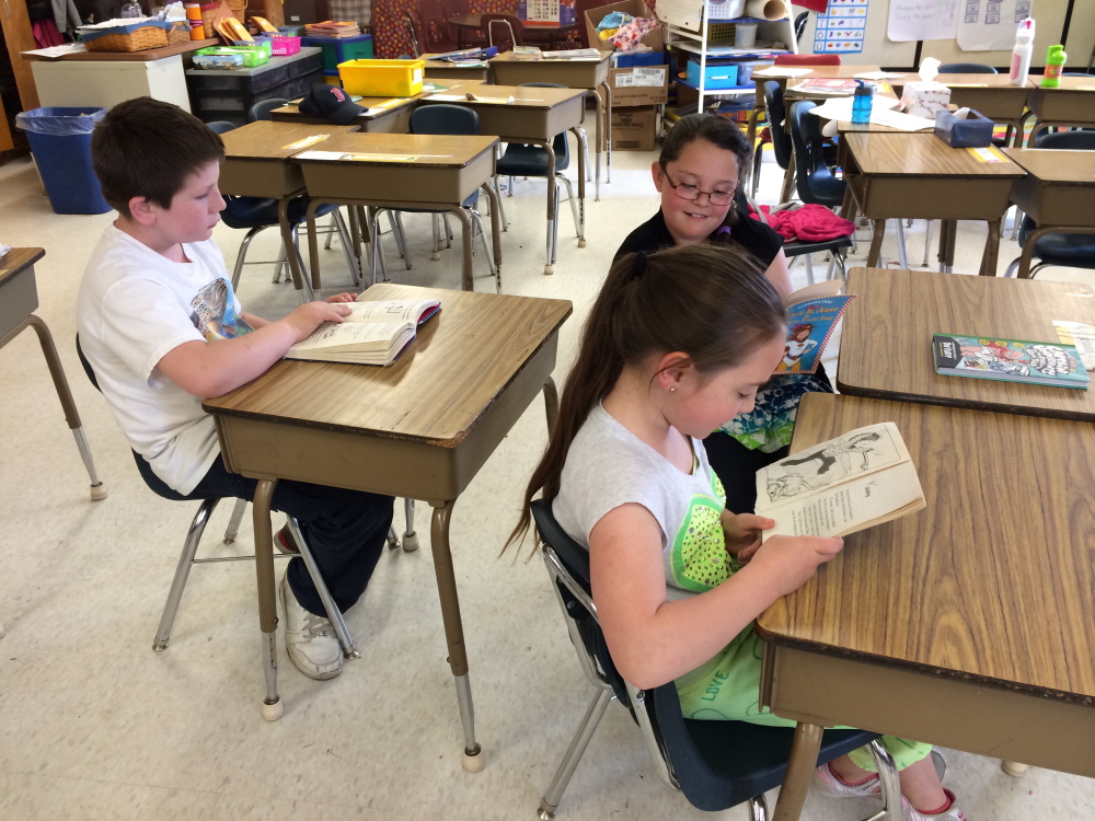 NEW GRADE: Third-grade students Jackie Dodge, front, Ahna Higgins and Troy Rodderick work on schoolwork at Bloomfield Elementary School in Skowhegan on Wednesday.