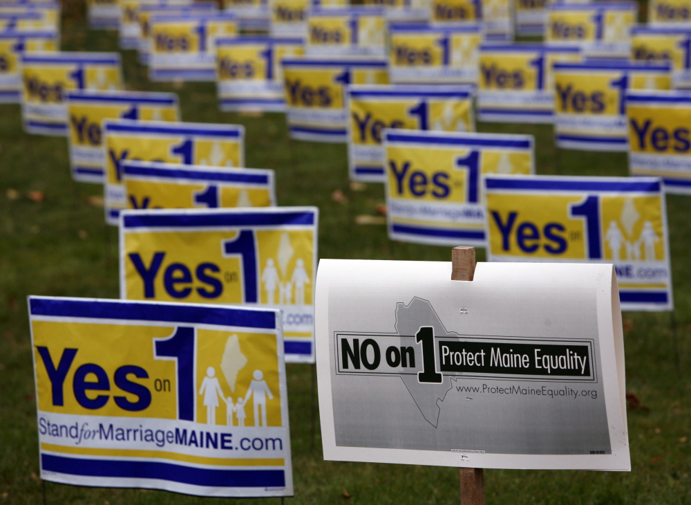 Posters urging Mainers to vote to repeal the state’s same-sex marriage law are displayed in Portland in 2009, along with a “No on 1” campaign poster. Maine’s ethics panel found that the National Organization for Marriage concealed its operations and donors during the campaign.