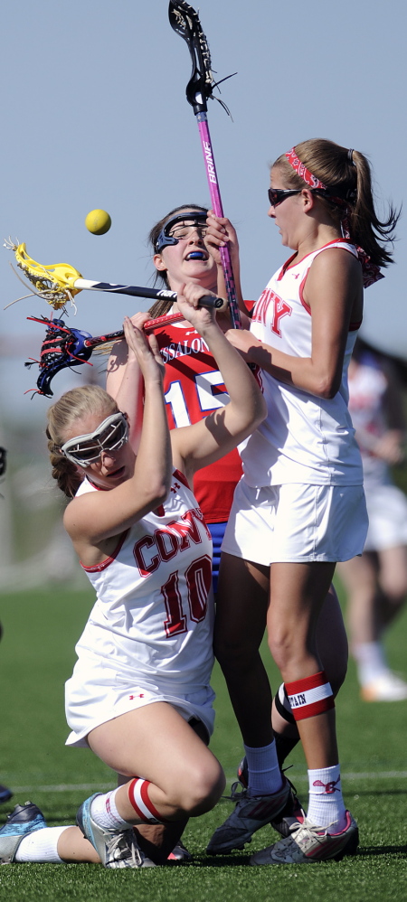 Staff photo by Andy Molloy COLLISION COURSE: Cony's Alexis Dostie, left, and Hayley Quirion collide with Messalonskee's Ally Fischang Thursday in Readfield.