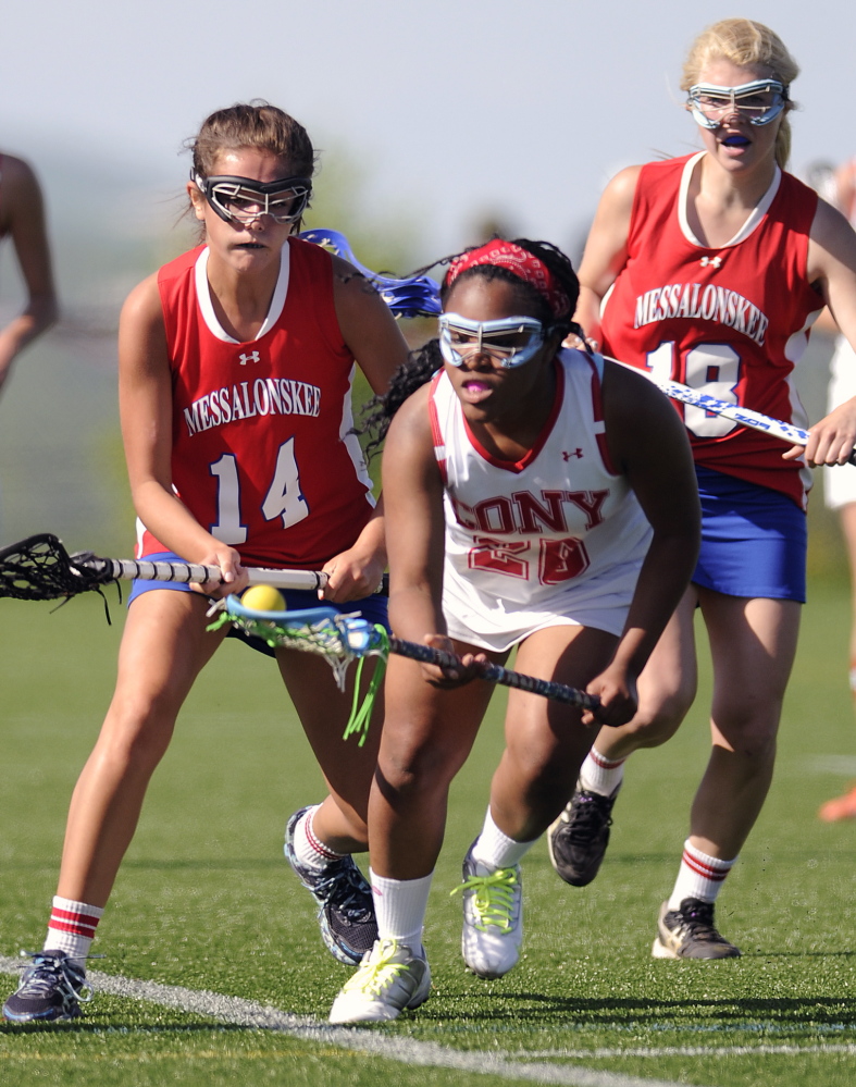 Staff photo by Andy Molloy UNDER PRESSURE: Cony's Tynisha Francois, center, collects the ball between Messalonskee's India Languet, left, and Nathalia St. Pierre Thursday in Readfield.