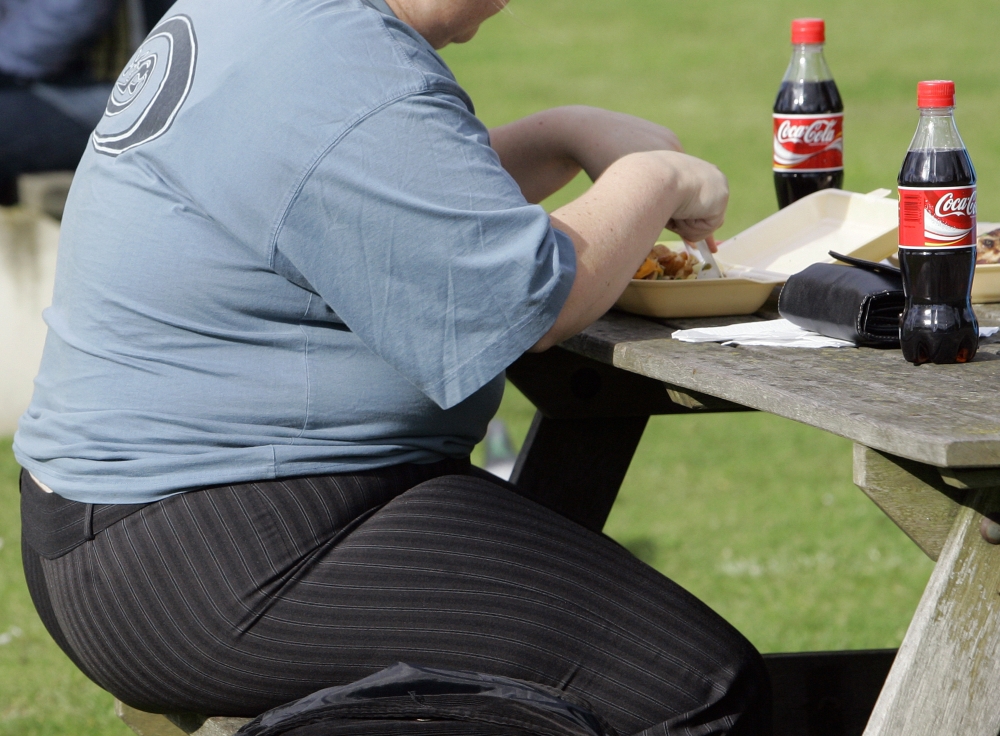 An overweight person eats in London. About two in three adults in the U.K. are overweight, making it the fattest country in Western Europe.