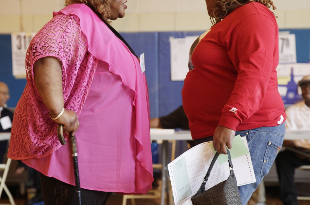 Two overweight women hold a conversation in New York in this 2012 photo. No country has been able to curb obesity rates in the last three decades, according to a new global analysis paid for by the Bill & Melinda Gates Foundation.