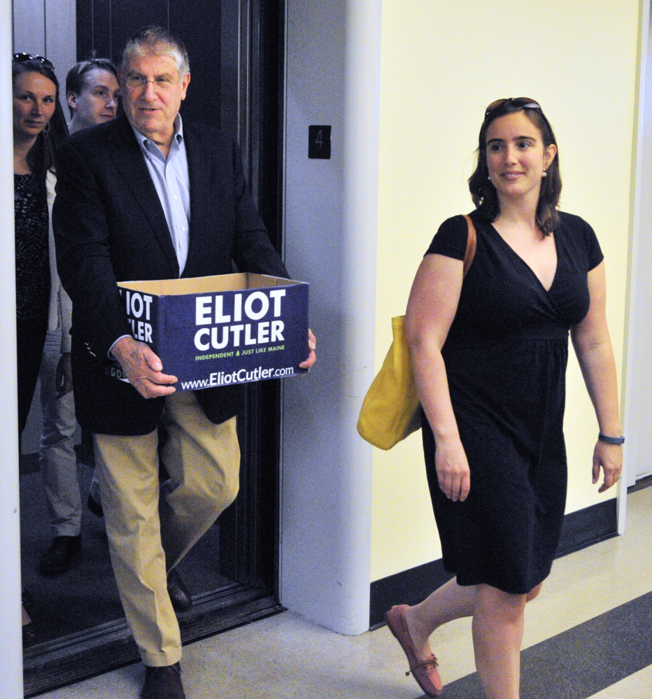 IT’S OFFICIAL: Independent candidate for governor Elliot Cutler, left, follows his deputy campaign manager Kaitlin Lacasse out of the elevator as they deliver petition signatures to the secretary of state’s office on Thursday in Augusta.