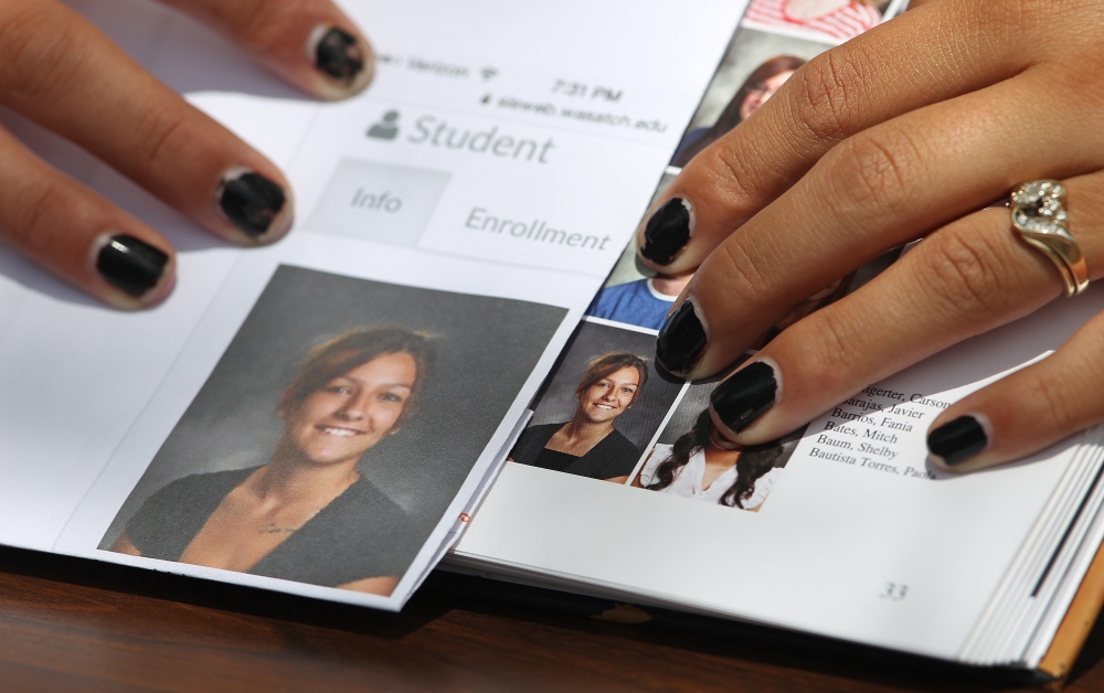 Sophomore Shelby Baum, 16, points to a Wasatch High School yearbook proof, left, and her altered yearbook photo, right, with a higher neckline drawn in.