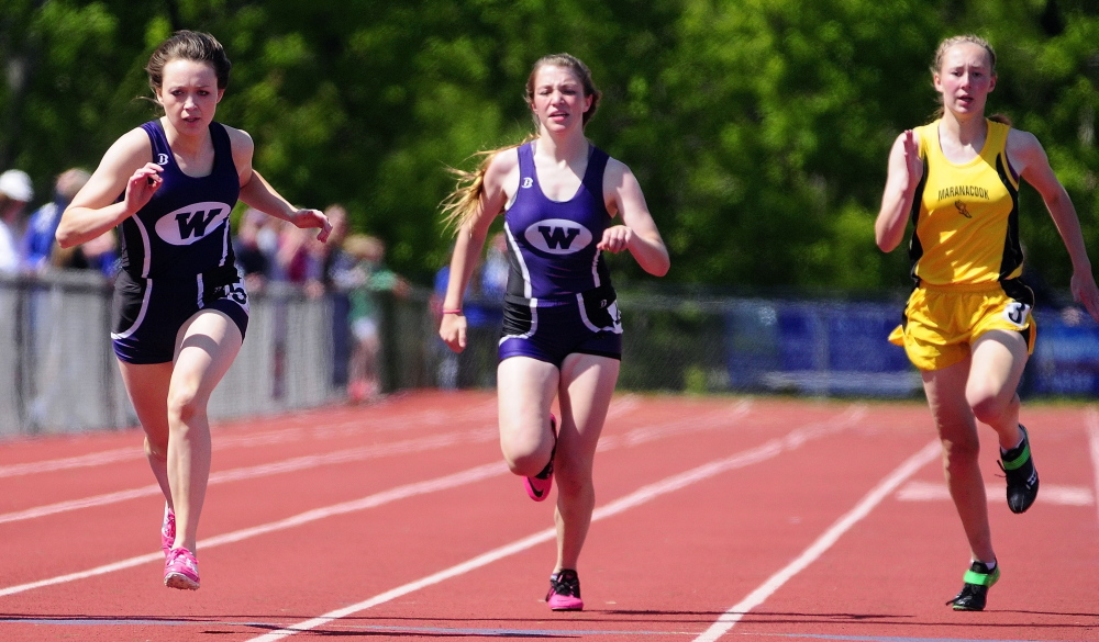 Runners: Waterville sprinters Amy Samson, left, Katherine Vince and Maranacook’s Lindsay Perkins head toward the 200 meter dash finish line during the KVAC track meet on Saturday in Bath.
