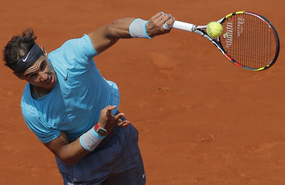 Spain’s Rafael Nadal serves to Argentina’s Leonardo Mayer during their third-round match of the French Open on Saturday in Paris. Nadal advanced with a 6-2, 7-5, 6-2 win.
