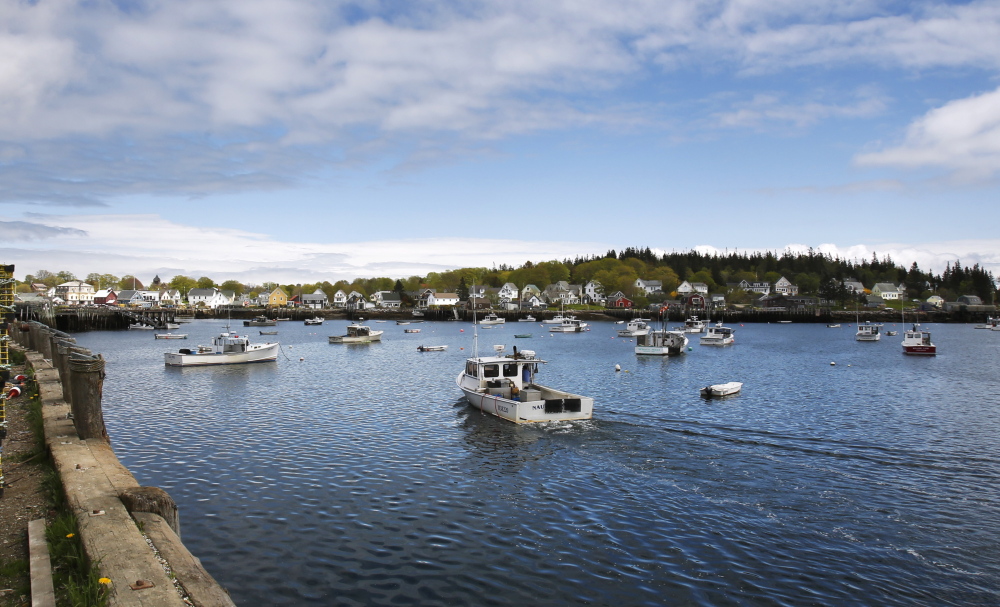 A lobster boat enters Carvers Harbor on Vinalhaven, off Maineâs midcoast, last month. The islandâs year-round residents number around 1,200. During the summer, its population swells to about 4,000.