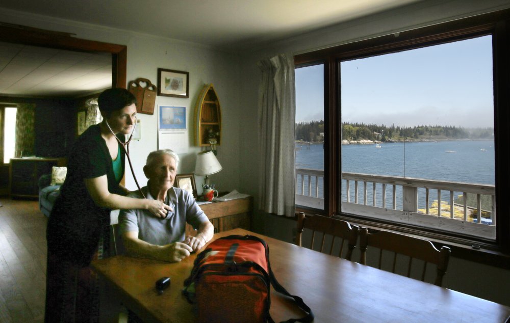 Nurse practitioner Jennifer Desmond checks on Harold âSonnyâ Warren at his home on Vinalhaven. Desmond âis the best thing to ever happen to Vinalhaven,â the 86-year-old lobsterman said. âSheâs stuck with us night and day. Six of the other doctors left.â Photos by Gregory Rec/Staff Photographer