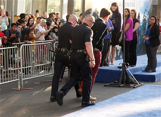 Vitalii Sediuk is walked off in handcuffs after allegedly accosting Brad Pitt at Wednesday's premiere of "Maleficent" at the El Capitan Theatre in Los Angeles.
