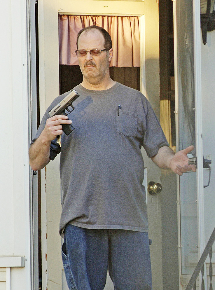 This photo taken by Barry Sturk, Susan Morissette’s boyfriend, shows her ex-husband, Wilfred Morissette, holding a handgun on First Street in Winslow Sunday night. Wilfred Morissette was arrested and charged after he allegedly pointed the loaded gun at Susan Morissette, Sturk and a teen.