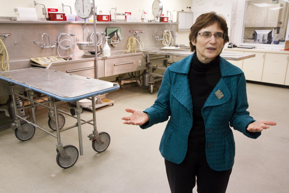 Dr. Margaret Greenwald talks about operations at the Office of Chief Medical Examiner inside the autopsy room in Augusta in April. Greenwald retired as Maine's chief medical examiner Friday, and the office was already struggling to find qualified medical staff.