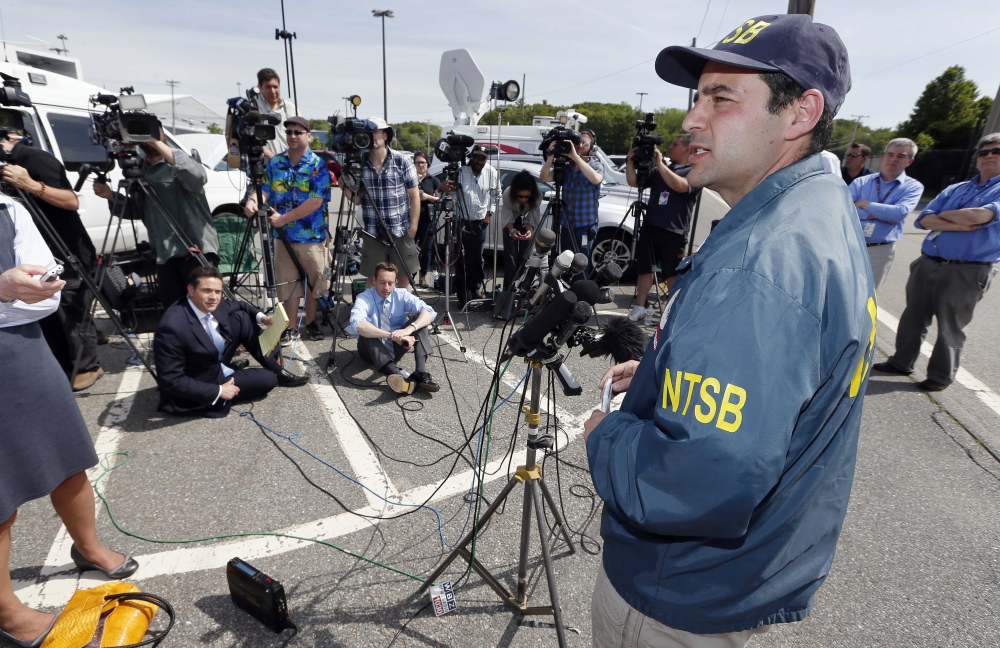National Transportation Safety Board senior air safety investigator Luke Schiada speaks during a news conference at Hanscom Field in Bedford, Mass., on Sunday, after a fiery plane crash killed seven people.