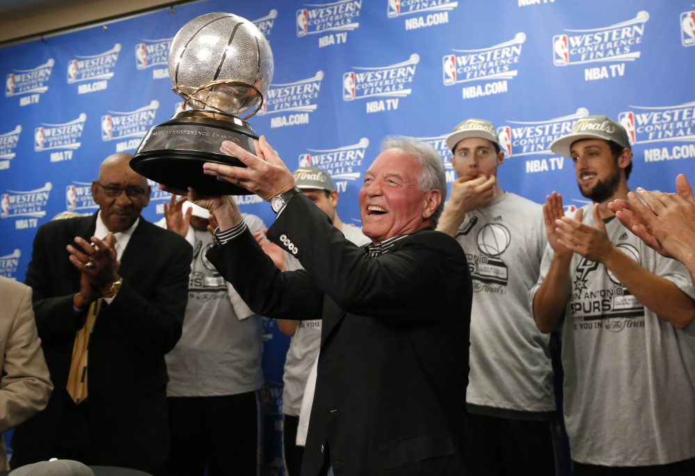 Spurs owner Peter Holt holds up the Western Conference trophy following Game 6 of the Western Conference finals Saturday night. The Spurs and Heat meet for the NBA championship for the second straight year. Miami won last year in seven games.