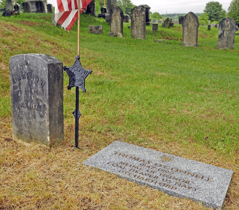 Staff photo by Joe Phelan HONORED: Town cemetery sexton Tom Reed recently installed a new marker for Thomas O’Connell, who won the Medal of Honor in the Civil War and is buried in Rest Haven Cemetery in Windsor.