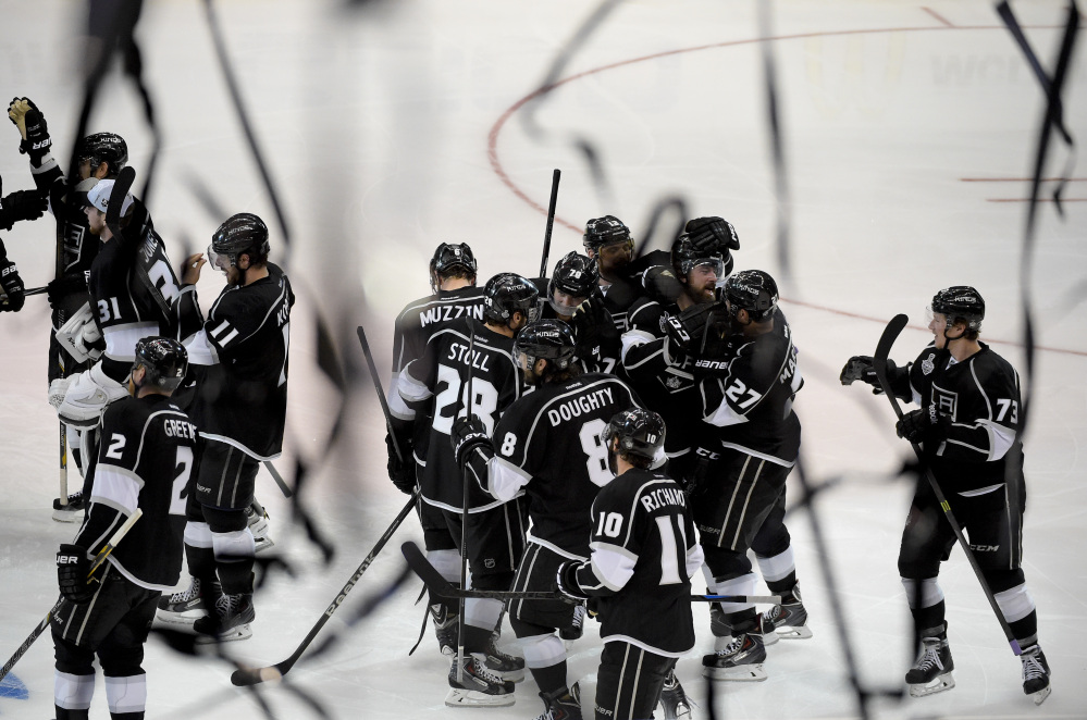 AP photo TOUGH WIN: Members of the Los Angeles Kings celebrate Justin Williams’s goal in overtime Wednesday of Game 1 of the Stanley Cup Finals hockey series against the New York Rangers in Los Angeles. The Kings won 3-2 and have a 1-0 series lead.