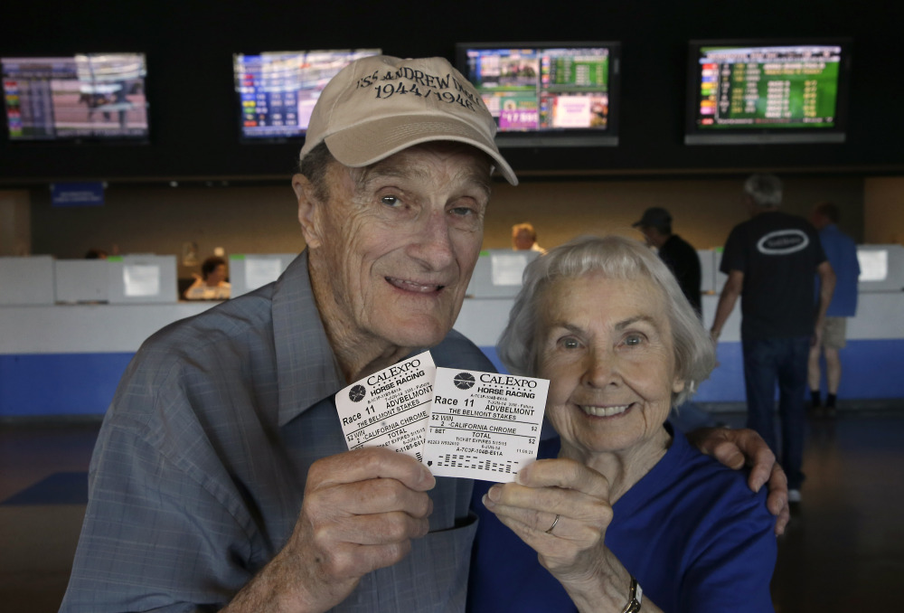The Associated Press/Rich Pedroncelli Harold Walter and his wife, Catherine, display their $2 advance wagers they placed on California Chrome, at the CalExpo racetrack in Sacramento, Calif. on June 6, 2014. California Chrome, the Kentucky Derby and Preakness Stakes winner, will attempt to become the first Triple Crown winner since Affirmed in 1978 when he races in the 146th running of the Belmont Stakes horse race on Saturday.