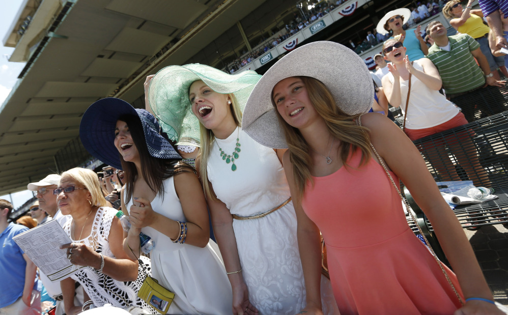 The Associated Press/Jason DeCrow Jen Hylkema, left, Rosalie Chamiel, center, and Annie Westlake cheer at Belmont Park before the Belmont Stakes horse race, Saturday, June 7, 2014, in Elmont, N.Y.