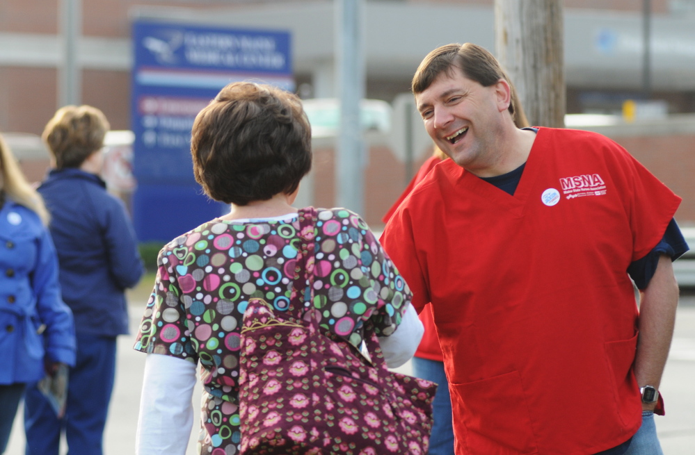 Kevin Bennett Photo Campaign: Troy Jackson greets hospital workers on the street in front of Eastern Maine Medical Center in Bangor recently.