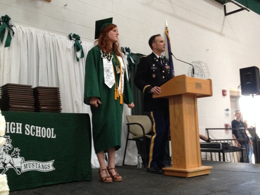 Staff photo by Matt Hongoltz-Hetling Accepted: West Point representative Joseph Lopes presents Hailey Davis with an appointment to the U.S. Military Academy during the Mount View High School graduation ceremony on Saturday in Thorndike. Davis is valedictorian of the graduating class.