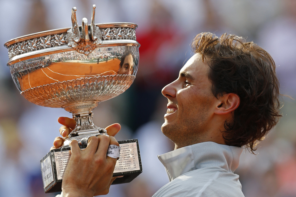 The Associated Press Rafael Nadal holds the trophy after winning the final of the French Open against Novak Djokovic Sunday in Paris.