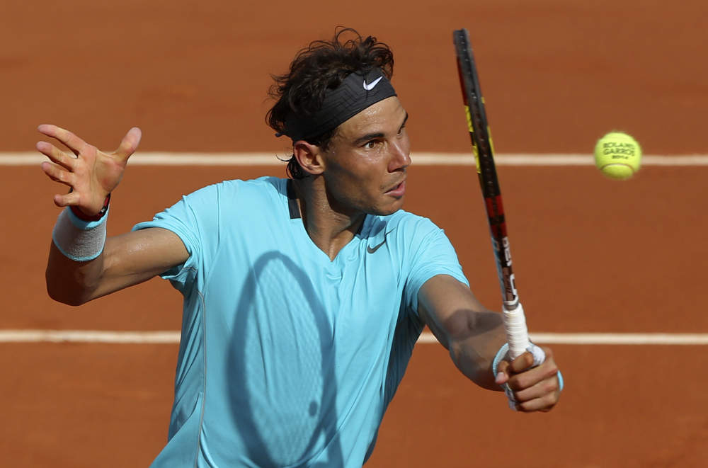 The Associated Press Rafael Nadal volleys the ball to Novak Djokovic during their final match of  the French Open Sunday. Nadal won his ninth French Open title with a 3-6, 7-5, 6-2, 6-4 win.