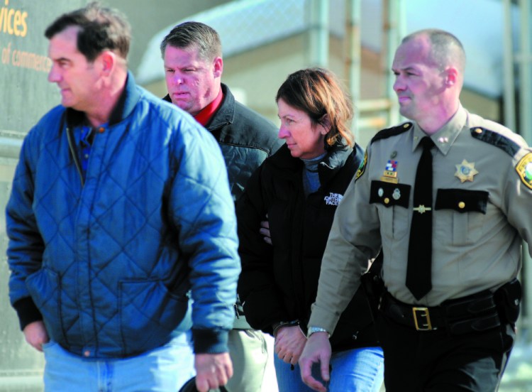 Staff file photo by Andy Molloy To be Sentenced: Former Chelsea Selectwoman Carole Swan, second from right, is led to the Kennebec County jail in handcuffs in 2011 after she was arrested at the sheriff’s office in Augusta. Swan was accompanied by, from left, her husband, Marshall Swan, after Detective David Bucknam and Sheriff Randall Liberty arrested her.