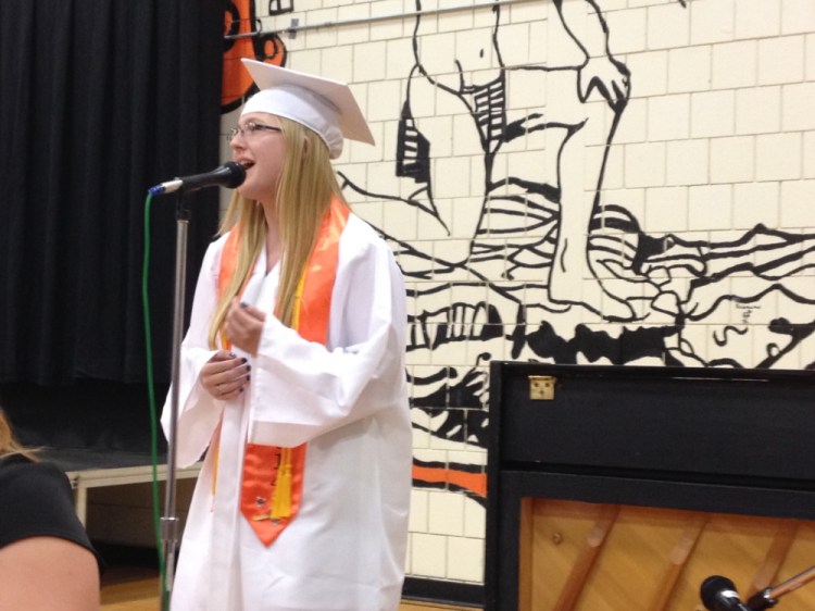 Photo by Matt Hongoltz-Hetling Singer: Brittany Hemphill sings “Whenever You Remember” to an estimated crowd of 800 during the Skowhegan Area High School graduation on Sunday afternoon.